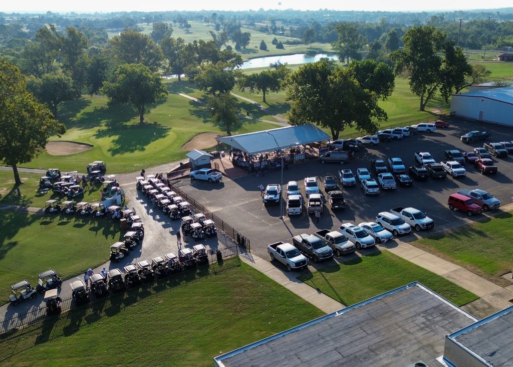 Pictured is an ariel view of cars and golf carts lined up and ready to hit the course during the Seminole State College Educational Foundation's 27th Annual Golf Tournament at the Jimmie Austin Golf Course.
