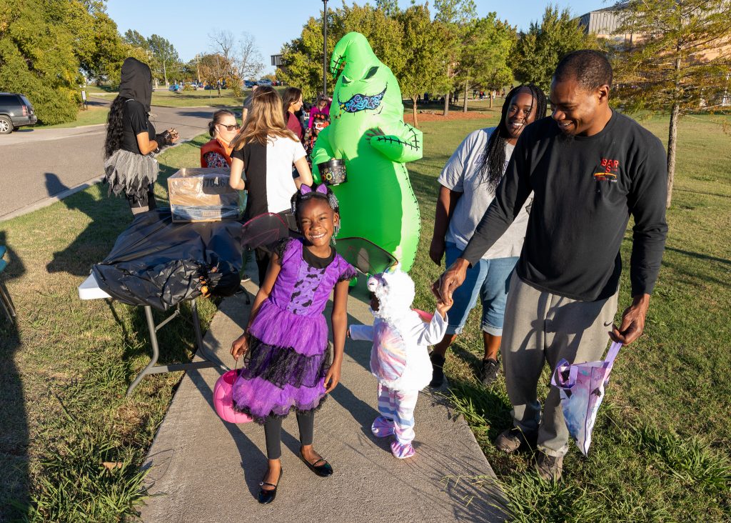 Pictured are Trick-or-treaters as they walked along the walking path in Henderson Park as faculty, staff and student organizations passed out candy.