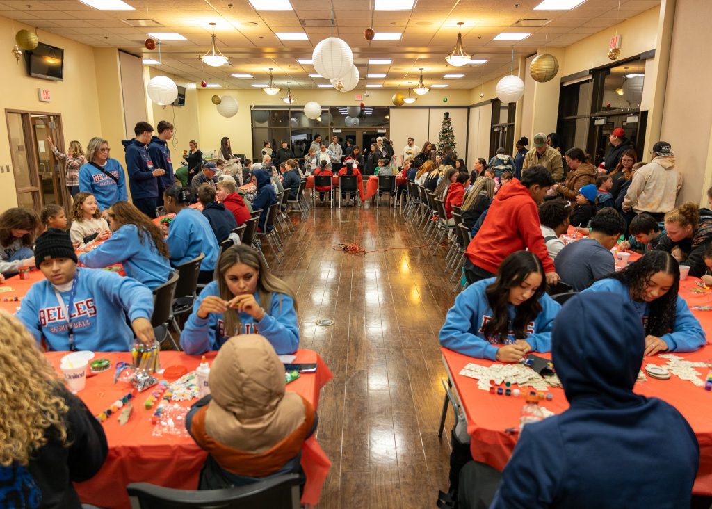 Pictured, Dozens of SSC students man crafting stations, helping children to create crafts.