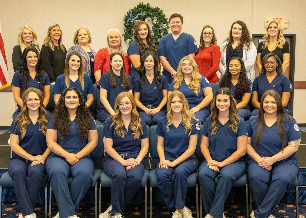 Pictured (left to right): Assistant Professor of Nursing Shelby Parsons, Nursing Program Office Manager Julie Mathews, Former Nursing Director Crystal Bray, Assistant Nursing Professor Ann Benson, Jami Hammond, Connor Martin, Assistant Professor of Nursing Damaila Lester, Assistant Professor of Nursing Miranda Stewart and Assistant Professor of Nursing Jessica Shelburne. Middle Row: Cheyanne Lee, Rebecca Smith, Shelly Teape, Kerra Pack, Presleigh Casteel, Serrenity Rezentes and Jada Hill. Front Row: Tina Buckmaster, Abigail Gilliam, Tara Gaines-Manship, Hayley Dale, Tosha Johnson, Casey Visnieski and Stephanie Newburn.