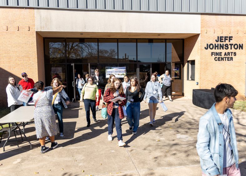 Pictured, students walk out of Jeff Johnston Fine Arts Center on the Seminole State College Campus.
