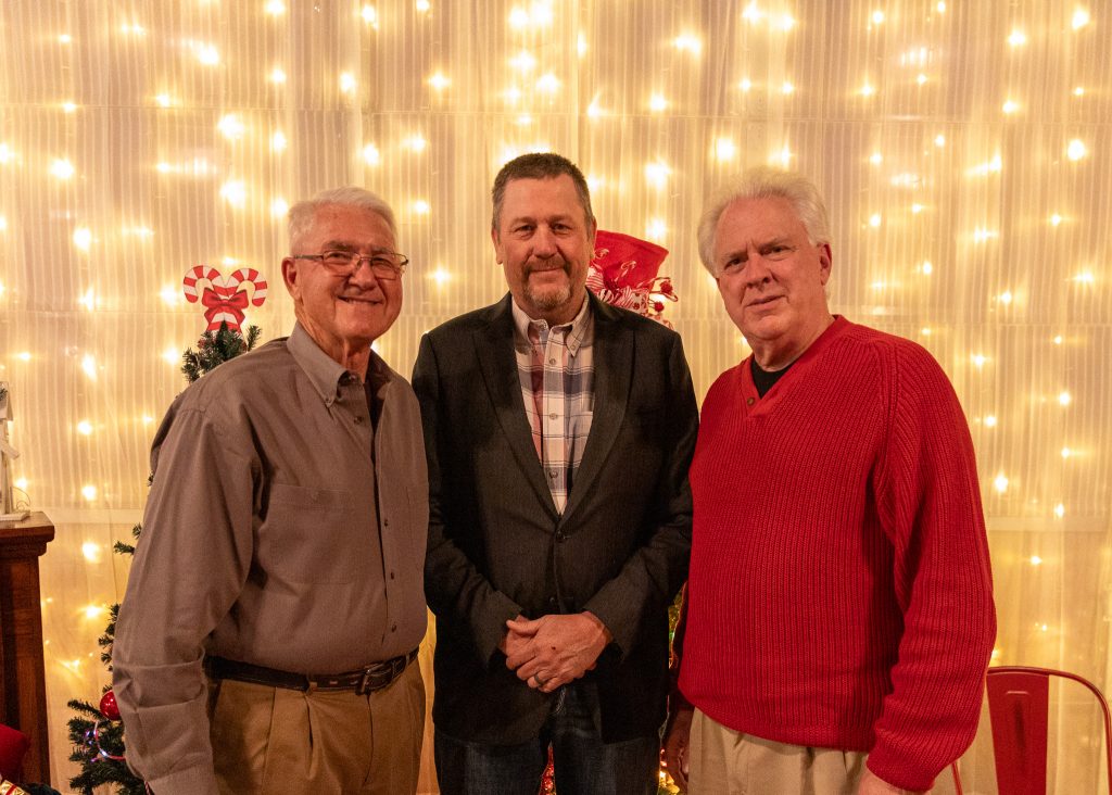 Former Oklahoma State Senators Harry Coates (left) and Charlie Laster (right) greet current State Senator Grant Green (center) at the Holiday Reception on Dec. 11.