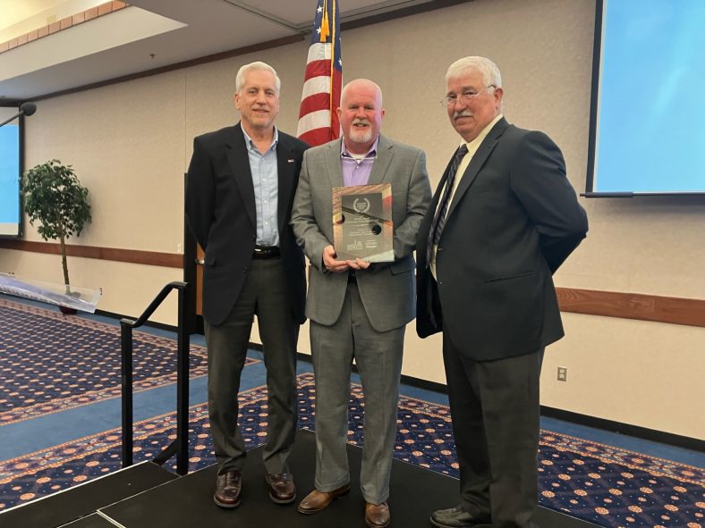 Picture, SSC Educational Foundation Vice Chair Mark Schell (left) and Chair Lance Wortham (center) accept the David L. Boren Community Achievement Award presented by Seminole Chamber of Commerce Chairman Rodney Sutterfield (right) at the chamber’s annual banquet on Feb. 6.