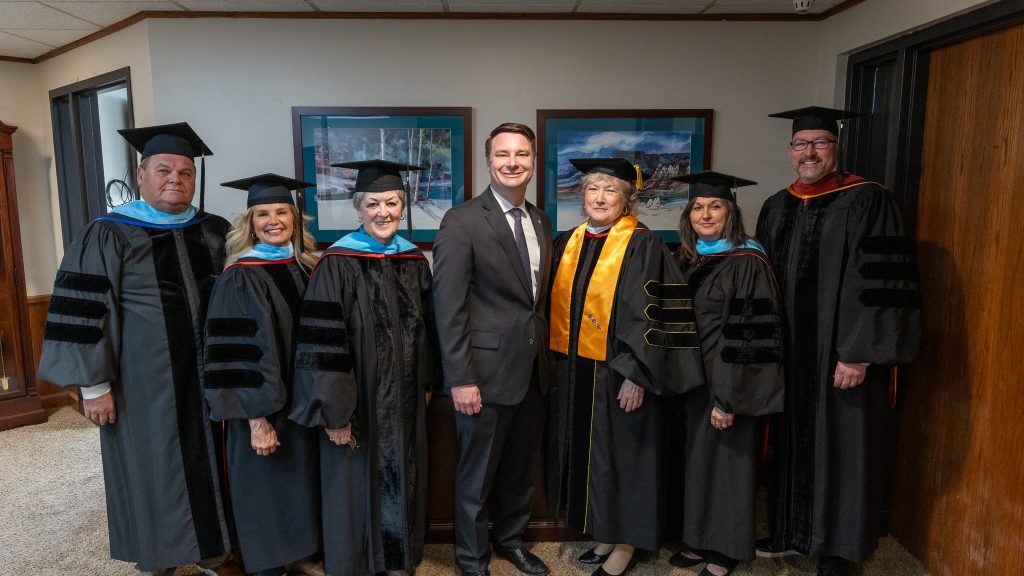 In this photo, pictured left to right are Regents Curtis Morgan, Robyn Ready, Marci Donaho, Speaker Hilbert, President Reynolds, Teresa Burnett and Bryan Cain.