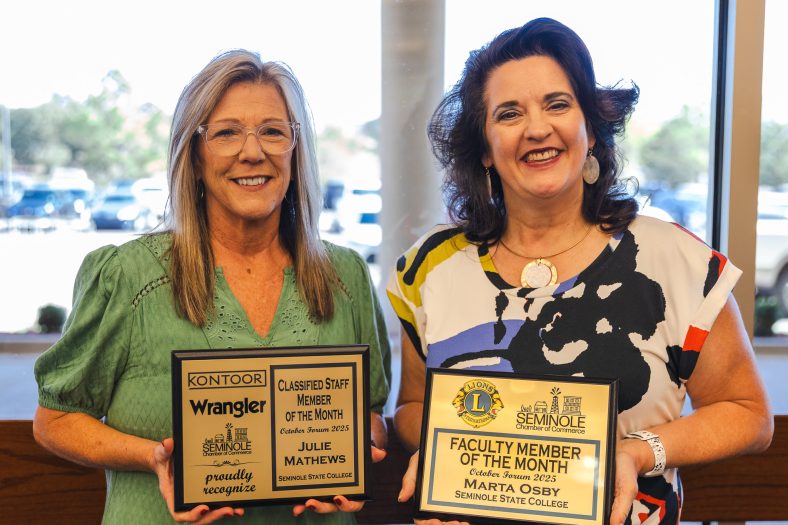 Mathews and Obsy pose with their awards following forum.