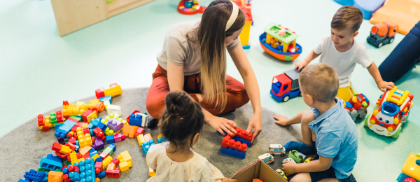 Decorative Image of Children and teacher at a daycare facility.