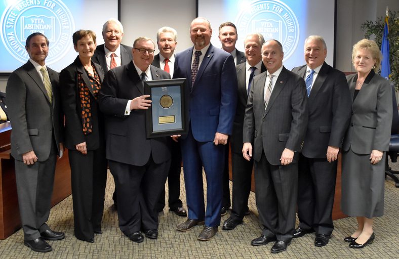 Pictured are, front row, Chancellor Glen D. Johnson, Wallace and Regent Jeffrey W. Hickman. Back row, left to right, are Northeastern State University President Don Betz, East Central University President Katricia Pierson, Regent Michael C. Turpen, Rogers State University President Larry Rice, Oklahoma Panhandle State University President Timothy Faltyn, Regent Joseph L. Parker Jr., Regent Andy Lester and Seminole State College President Lana Reynolds.