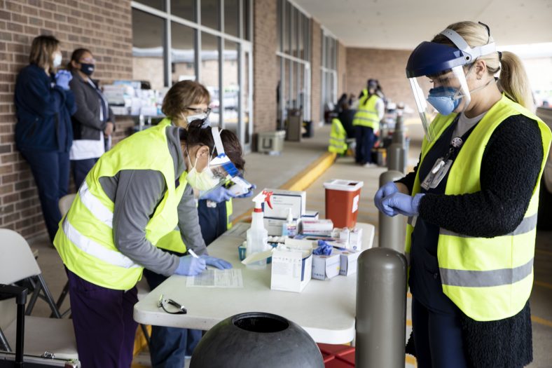 Nurses prepare to administer flu shots.