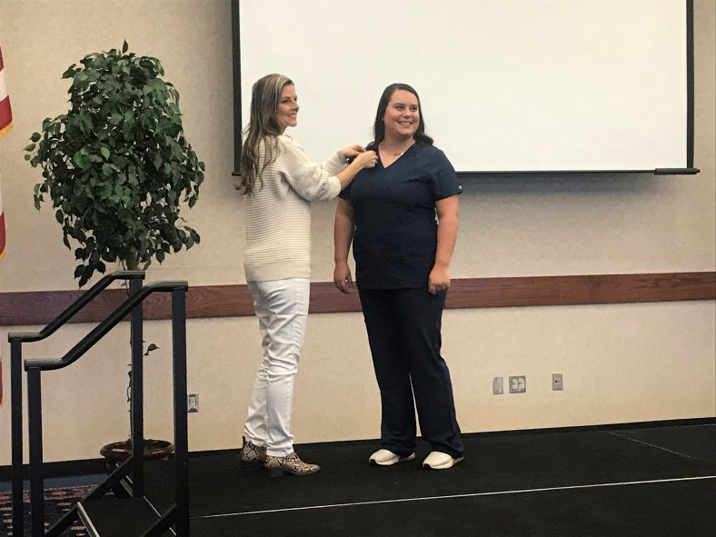 Student participates in pinning ceremony.