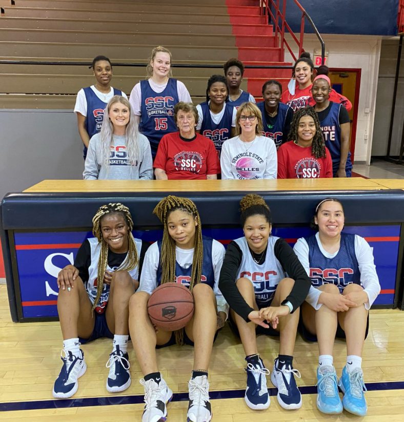 Players and coaching staff of the 2020-2021 Seminole State College Belles basketball team pose for a photo with former Belles Coach Dixie Woodall.