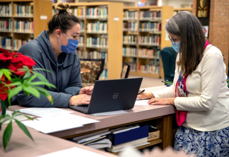 SSC Student Lacy Fisher (left) is assisted by Librarian Robin Tyler (right)