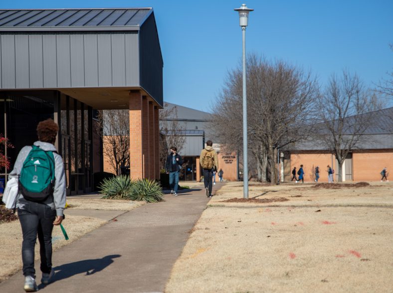 Students walking on the sidewalk between classes