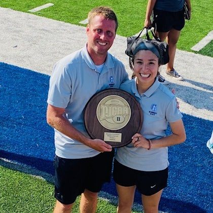 Trojans soccer Head Coach Dan Hill (left) and Assistant Coach Chely Flores (right) celebrate after the team won the Region II Tournament last month. Hill was named the 2021 Region II Women’s Soccer Coach of the Year.