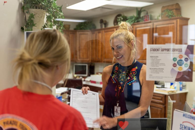 SSC Admissions Clerk Jessica Guinn assists a student with enrollment ahead of extended office hours taking place Aug. 9-14.