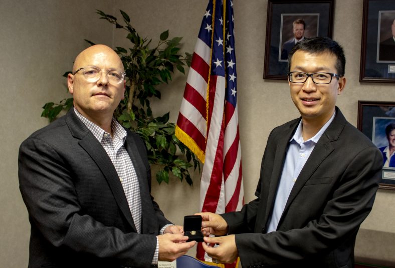SSC Board of Regents Chair Ray McQuiston (left) presents Associate Professor of Business Dr. Chunfu “Jeff” Cheng (right) with a pin, recognizing him for his five years of service as a sponsor of the Phi Theta Kappa honor society at the Board of Regents meeting on Oct. 21.