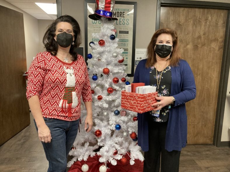 SSC Professor of History Marta Osby (left) presents Assistant for the Center of Development and Civic Engagement C. Kimberly Henry (right) with a collection of thank you and holiday cards for veterans at the VA Hospital in Oklahoma City.
