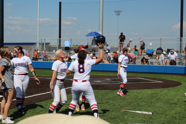 Softball players celebrate after winning game