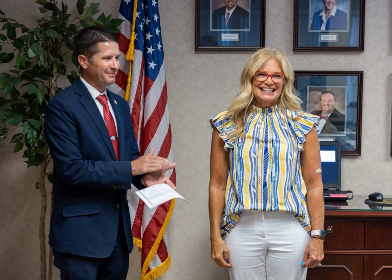 New Regent Robyn Ready (right) completes her oath of office administered by State Senator Zack Taylor (left) on July 21