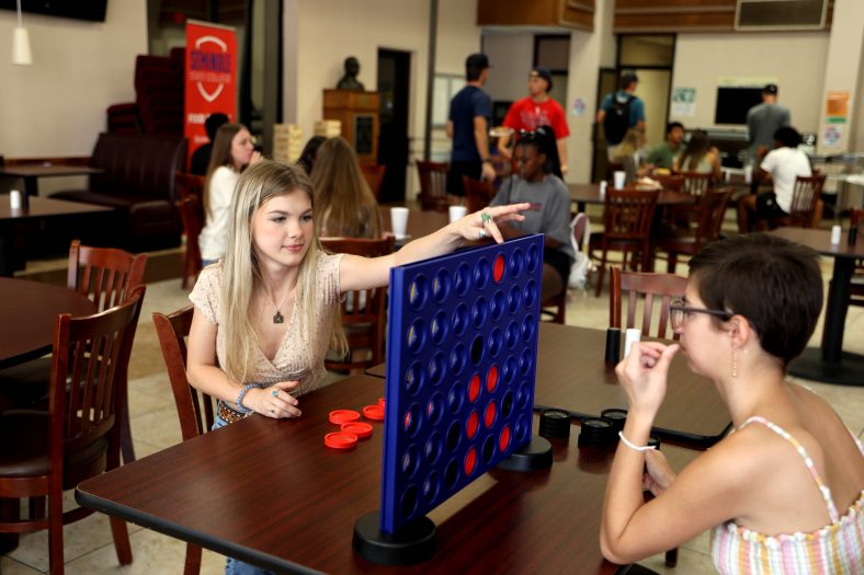 Two students play a game of Connect Four