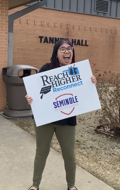 SSC Online Degree Navigator Caitlin Brown stands outside of Tanner Hall, where prospective students are invited to attend the Reach Higher: Reconnect event on June 20 and 21.