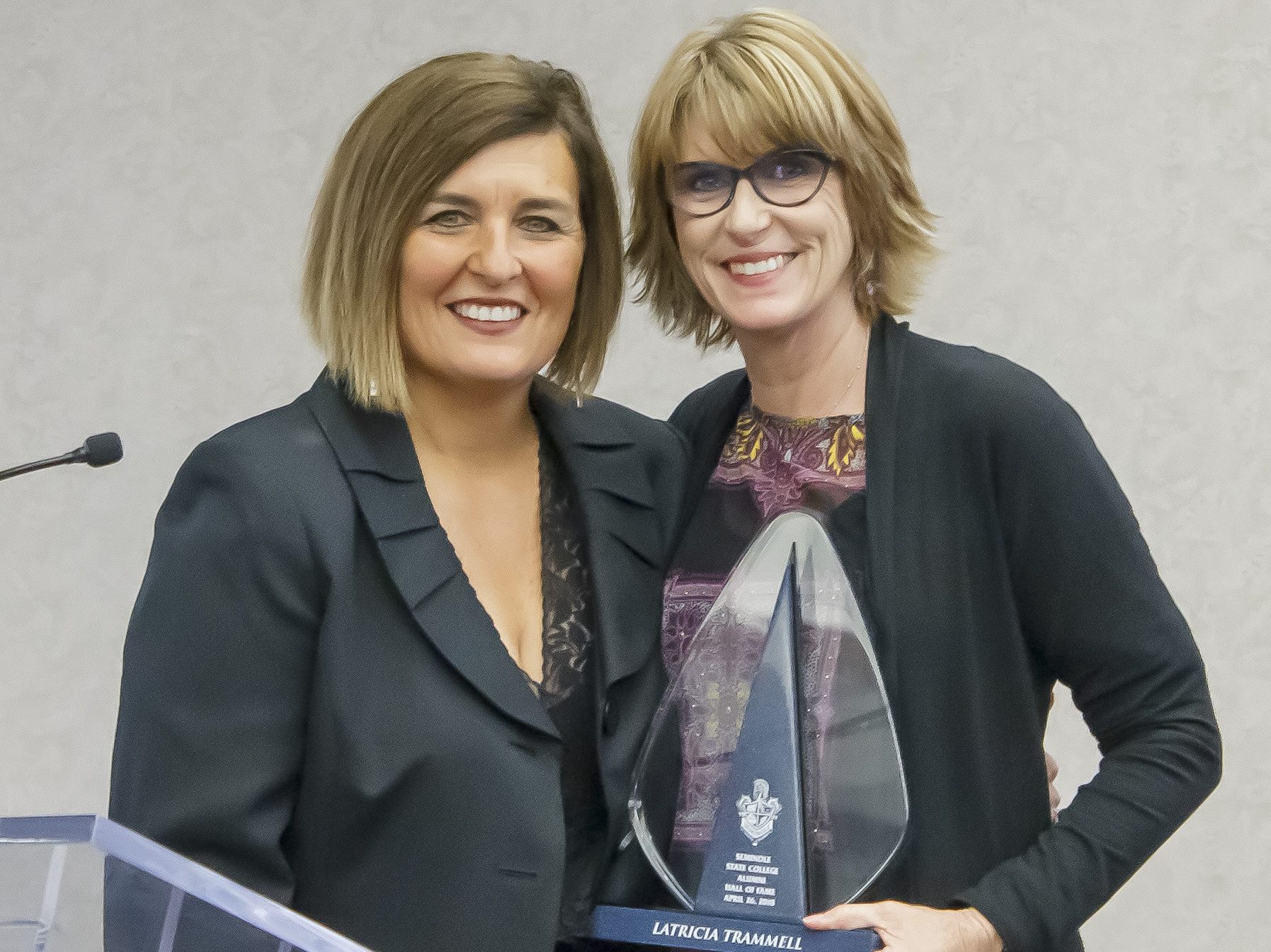 SSC Belles Basketball Coach Rita Story-Schell (right) inducts WNBA Coach Latricia Trammell (left) into the Seminole State College Alumni Hall of Fame on April 26, 2018.