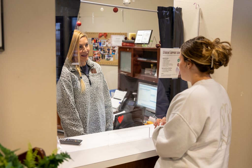 Seminole State College freshman Haley Smith (right), of Seminole, speaks with Admissions Clerk Jessica Guinn (left) about enrollment on Jan. 5.