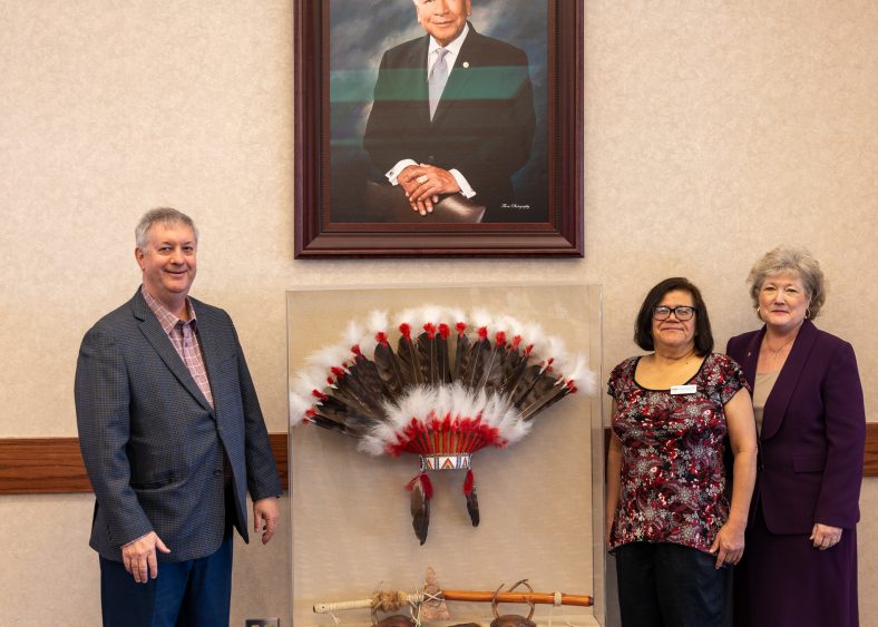 Pictured, Seminole State College Educational Foundation Trustee and Vision Bank President and CEO Steve Bagwell (left) recently donated several prints of artwork by Kelly Haney and other items to SSC. SSC Talent Search Advisor Damaris Haney (center), the daughter of Kelly Haney, and President Lana Reynolds (right) accepted the donation on behalf of the College.