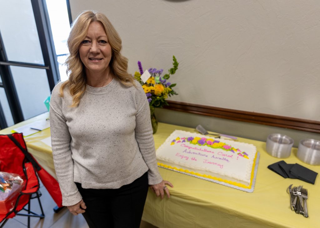 Pictured is Fiscal Affairs Administrative Assistant Carol Landes standing next to her cake at a retirement reception held for her in the E.T. Dunlap Student Union on March 28.