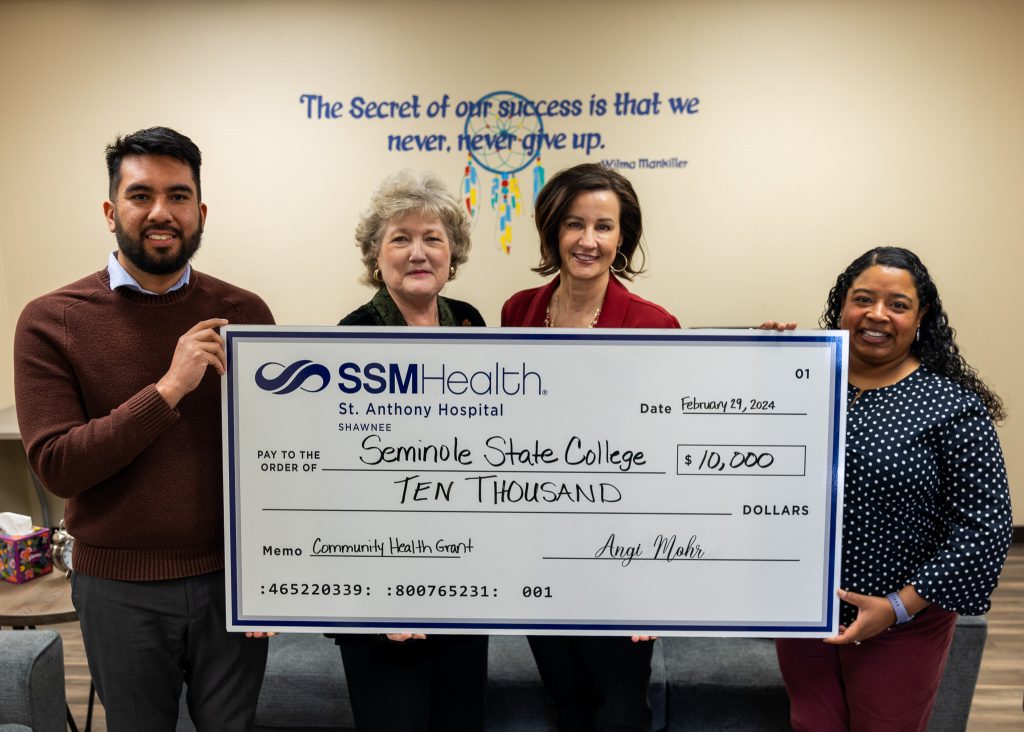 Pictured (left to right): SSM Health Senior Community Health Specialist Jose Rojas, SSC President Lana Reynolds, SSM Health St. Anthony – Shawnee President Angi Mohr and Psychology Professor and Help Center Coordinator Christal Knowles hold up a check representing the recently received community health grant from SSM Health St. Anthony – Shawnee.