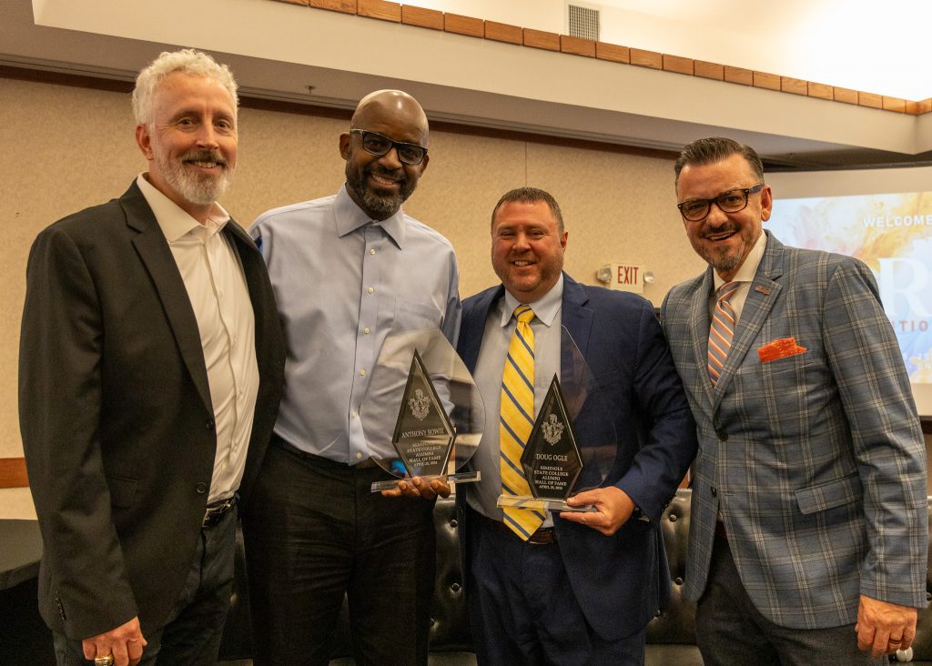 Pictured posing for a photo are Former SSC students Anthony Bowie (center left) and Doug Ogle (center right) who were inducted into the SSC Alumni Hall of Fame. Vice President of Commercial Lending at First National Bank of NWA Kyle Kerwin (left) and Senior Associate Athletic Director of Development for OSU Athletics Larry Reece (right) presented the awards.