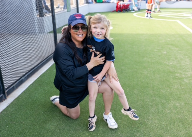 Pictured is Emma Bilyeu of Prague (right) as she stops and says hello to SSC Softball Head Coach Amber Flores (left).