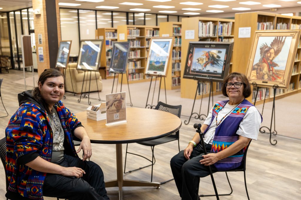 Pictured is Seminole State College Talent Search Advisor Damaris Haney (right) discussing the artwork of her father, Kelly Haney, with SSC freshman Mark Factor of Seminole. Kelly Haney’s artwork was prominently featured during the College’s “SSC, the Arts and Me” event on April 17.
