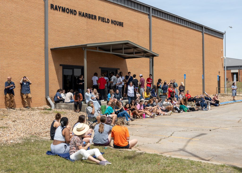 Pictured is a large group of faculty, staff and students gathered outside on SSC's campus to watch the solar eclipse.