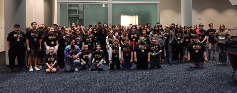 A large group of SSC Talent Search/FOCUS students, staff, and volunteers pose for a photo after they enjoyed dinner together at Logan's Roadhouse and attended Harry Potter and the Chamber of Secrets in Concert at the OKC Civic Center on April 26.