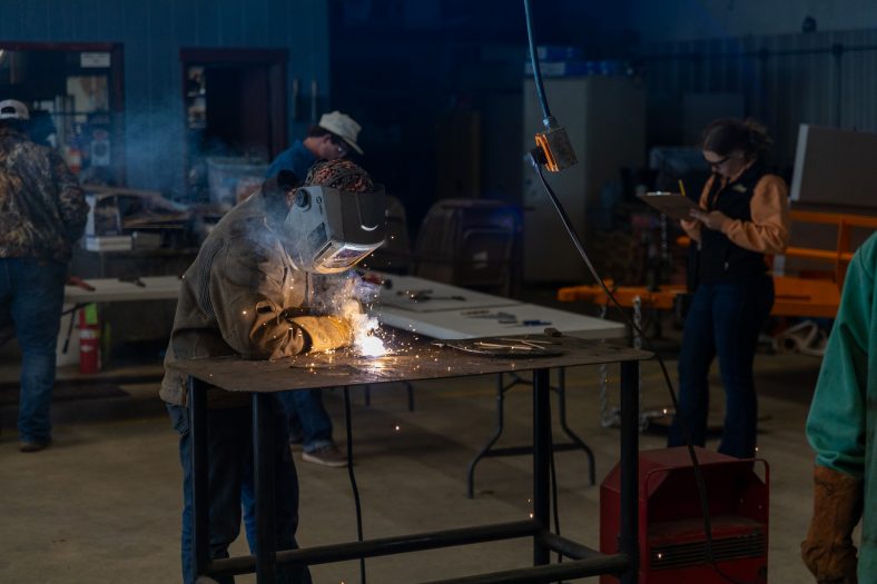 Pictured is a High school FFA student competing in the Ag Mechanics (welding) contest.