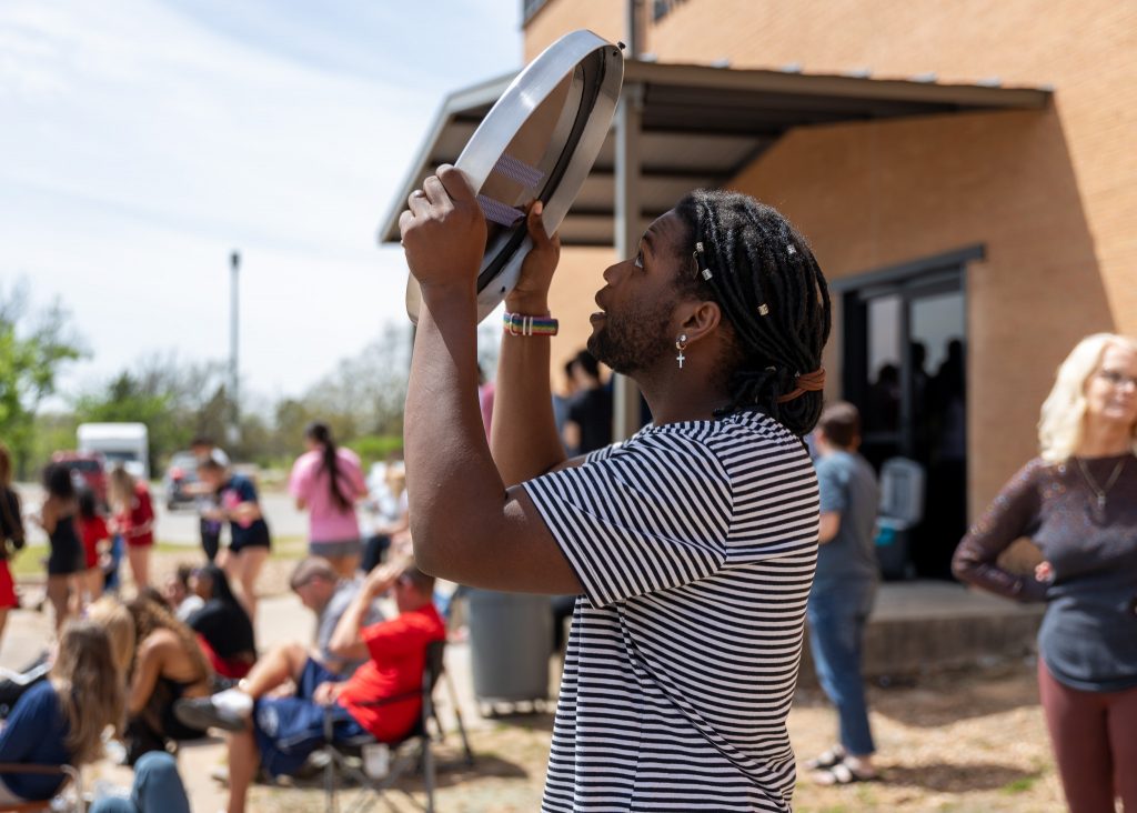 Pictured is Upward Bound Coordinator Jay Williams as he observes the eclipse through a one-way mirror at SSC’s watch party.