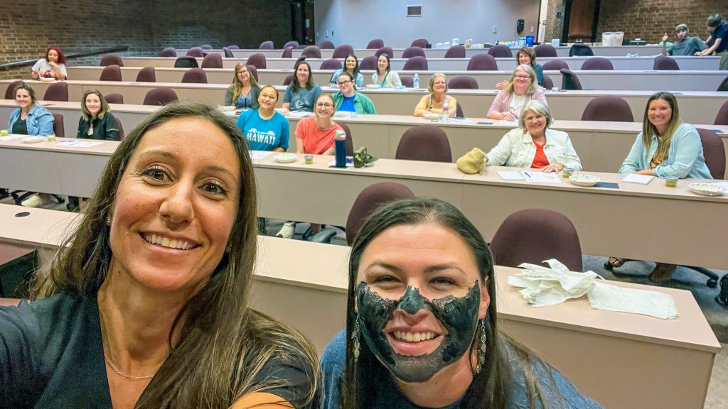 Seminole State College Business and Industry Training Coordinator Talina Lee (right) experiences a hands-on demonstration of a charcoal mud face mask, led by Natural Remedies class instructor Jacqueline Bourne (left) on May 15. The community course, “Natural Beauty: Where Nature Meets Self-Care,” explored holistic methods for enhancing hair, skin and nail health. Students also created essential oil salt scrubs during the session. Lee coordinates a range of non-credit courses for the public through the College’s Business and Industry department.