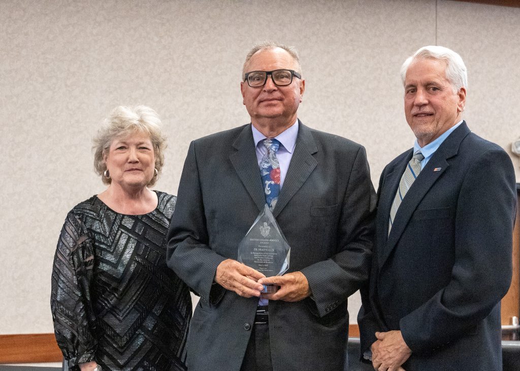 Pictured, Seminole State College President Lana Reynolds (left) and SSC Educational Foundation Chair Mark Schell (right) present the Distinguished Service Award to Dr. Brad Walck during the SSC Educational Foundation’s 30th Annual Spring Recognition Banquet on May 1. Walck was honored for his 22 years of service at SSC, where he held several roles including Vice President for Student Affairs and Head Women’s Basketball Coach.