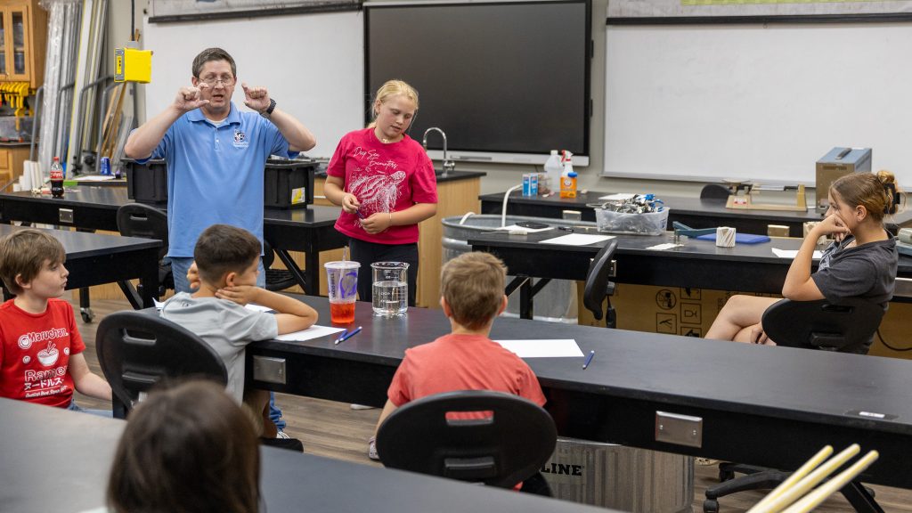 In this photo, SSC Professor of Mathematics Jarrod Tollett speaks with students during the STEM – Aquatic Robots class.