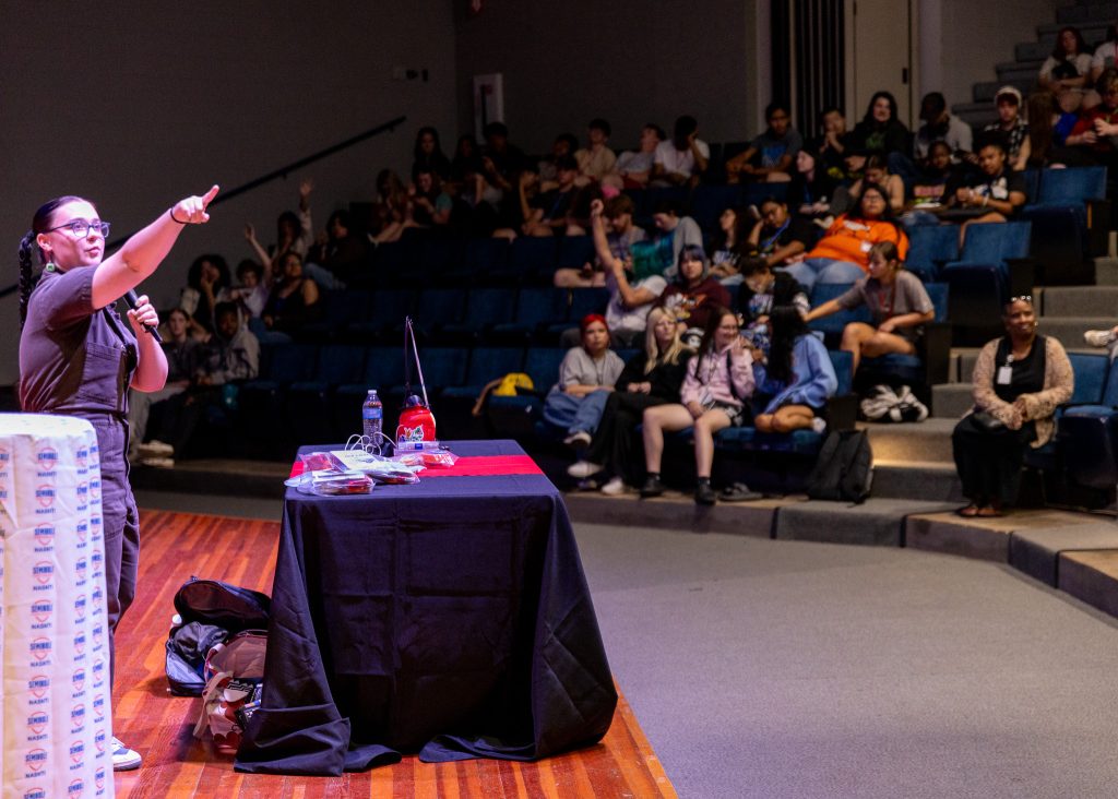 In this photo, Danielle Boyer, citizen of the Sault Ste. Marie Tribe of the Chippewa, speaks at the Jeff Johnston Fine Arts Auditorium on June 16. 