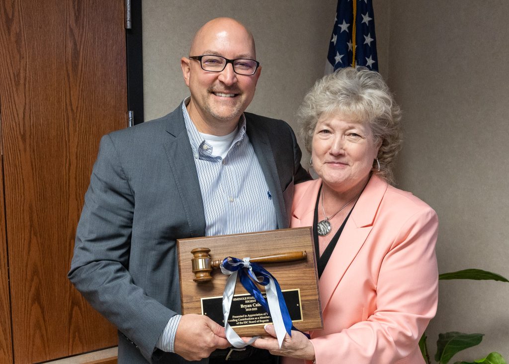 SSC Board of Regents member Bryan Cain (left) was recognized for his service to the College at the meeting on June 9. Following the meeting, President Lana Reynolds (right) presented him with a plaque and gavel, commemorating his time at the College.