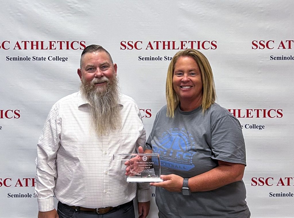 Seminole State College Vice President for Academic and Student Affairs Dr. Bill Knowles (left) presents Athletic Director Leslie Sewell (right) with a plaque recognizing her completion of the Advanced Leadership Track of the 2024-2025 Council on Student Affairs Leadership Academy.