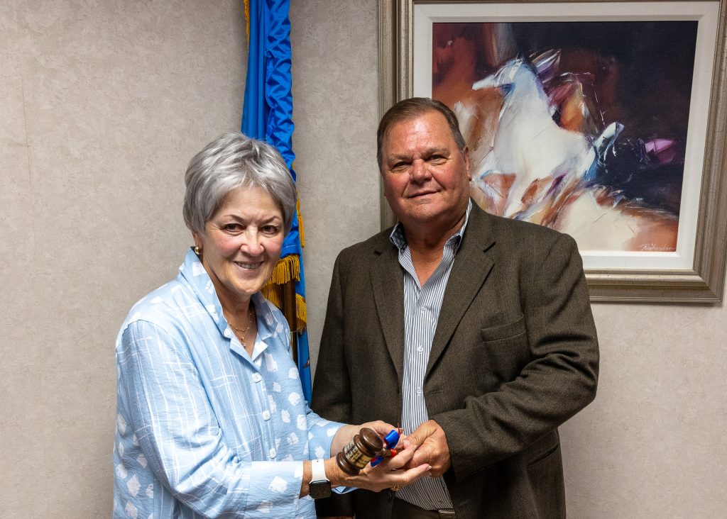 In this photo, Regent Curtis Morgan (right), who served as Chair of the SSC Board of Regents for the 2024-2025 academic year, passes the gavel to the newly elected 2025-2026 Chair Marci Donaho (left).