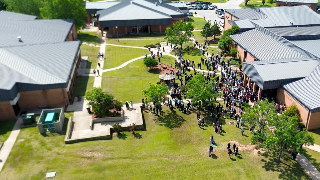In this photo, an arial view of students, family members, faculty and staff is shown on the SSC campus after graduation.