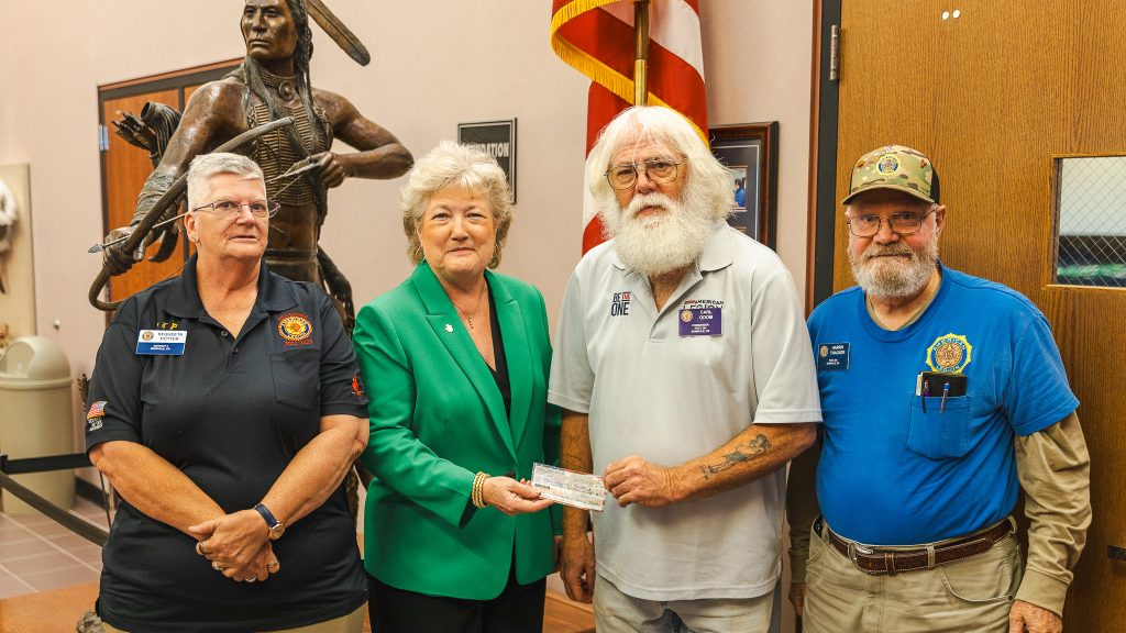 American Legion Post 204 members present SSC President Lana Reynolds with a check to support upcoming Veterans Day activities on campus.