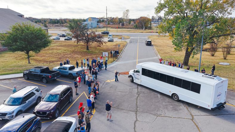 In this photo, an ariel view is shown of a crowd lining the road as the women’s soccer team departs campus.