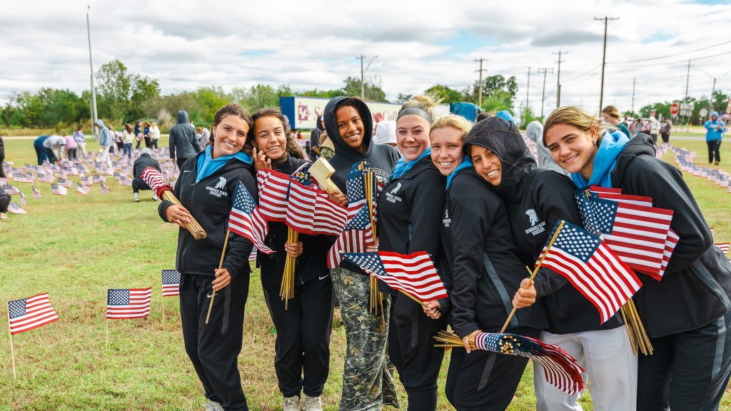 In this photo, SSC women’s soccer players lend a hand planting American flags on SSC’s campus. Pictured from left are Molly-Kate Lundy of Lewisville, Texas; Zoe Trenchard of Lewisville, Texas; Jillian Powell of The Colony, Texas; Bry Russell of Flower Mound, Texas; Bella Mattingly of Flower Mound, Texas; Ashlynn Vargas of Pryor; and Madelyn Jones of Wylie, Texas.