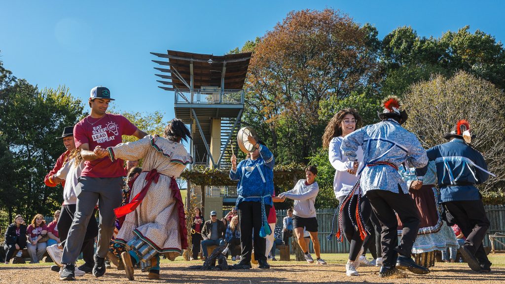 In this photo, PLC students join a Stomp Dance demonstration at the Chickasaw Cultural Center.