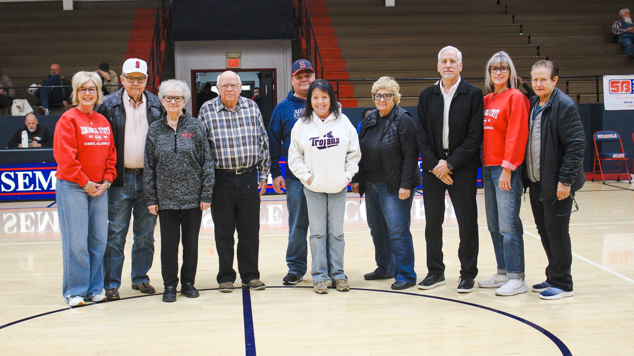 In this photo, Pictured left to right prior to the half-court presentation are: Kim Hyden, Jim Hardin, Dr. Jim Hardin, Les Walker, Curtis Morgan, Pam Morgan, Sue Snodgrass, Mark Schell, Rita Story-Schell and Hope Pickering.