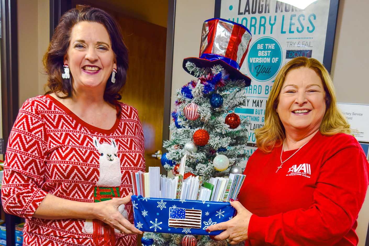 In this photo, SSC Professor of History Marta Osby (left) presents Melissa Overfield, Chief of Voluntary Services, with holiday cards for veterans at the Oklahoma City VA Medical Center.